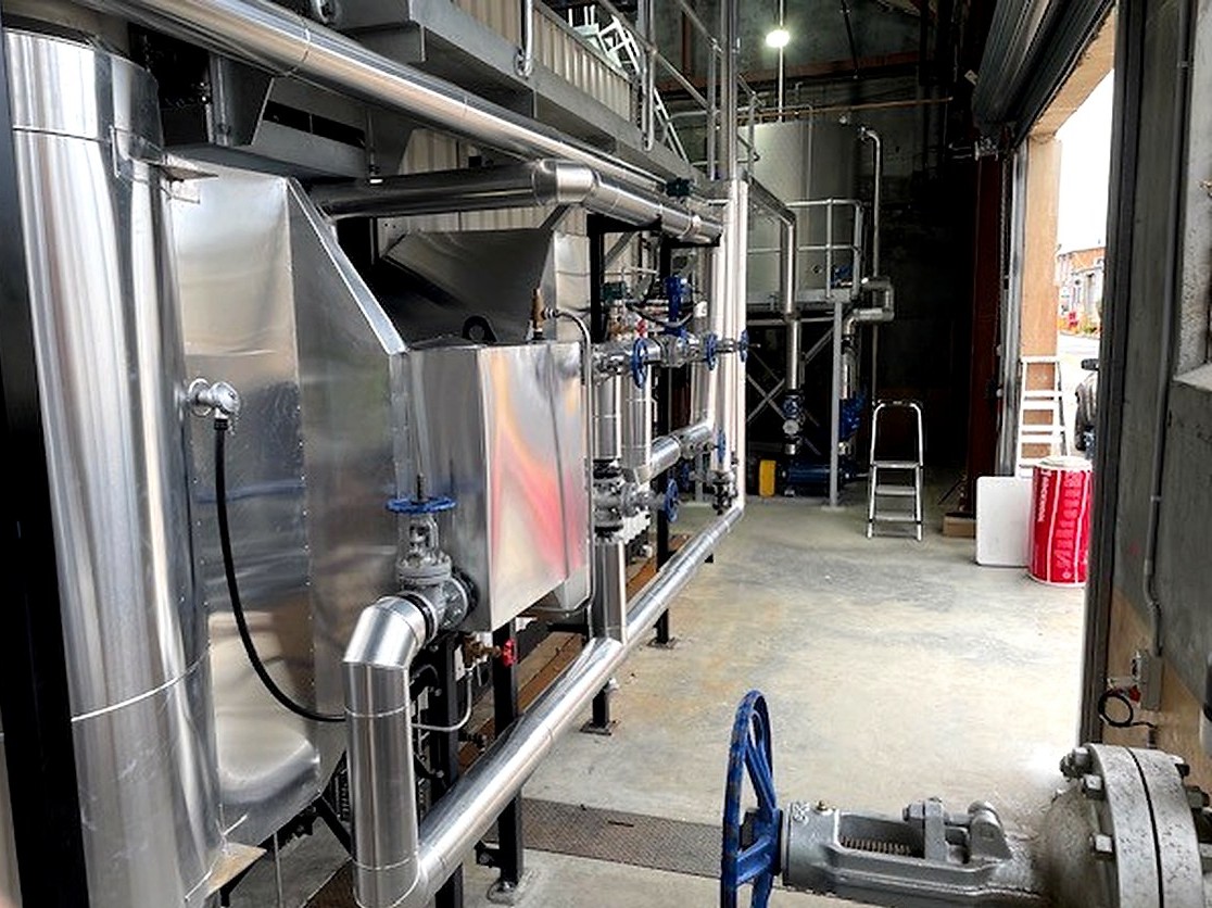 Custom flat panel sheet metal cladding fitted to industrial process equipment and associated pipework